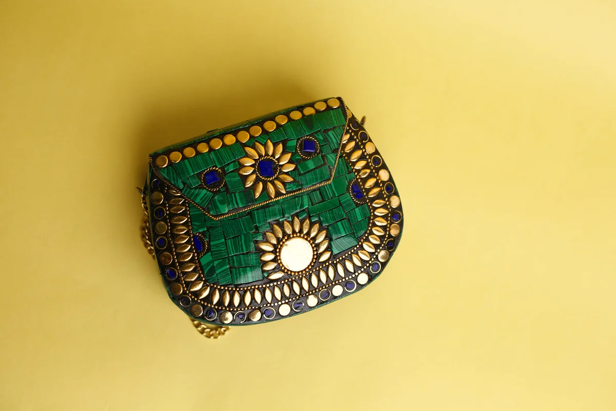 Antique-style handbag with gemstone details and gold trim